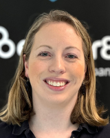 Headshot of Samantha Davis smiling in front of a black backdrop.
